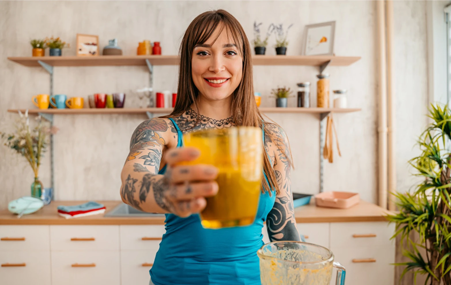 Woman presenting health drink directly toward viewer